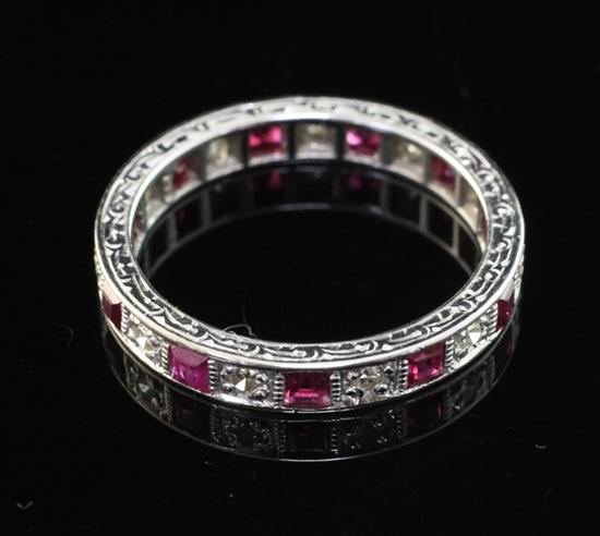 An 18ct white gold, ruby and diamond full eternity ring, size M.
